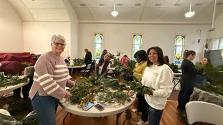Holiday greens wreath workshop — participants creating fresh evergreen wreaths
