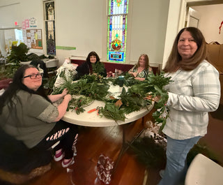 Holiday greens wreath workshop — participants creating fresh evergreen wreaths